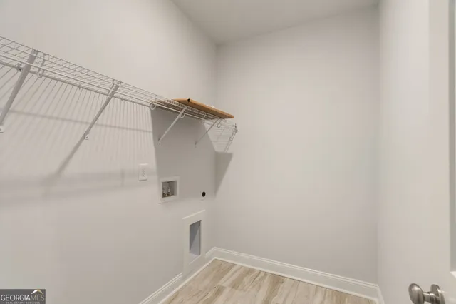 an empty room with windows and ceiling fan