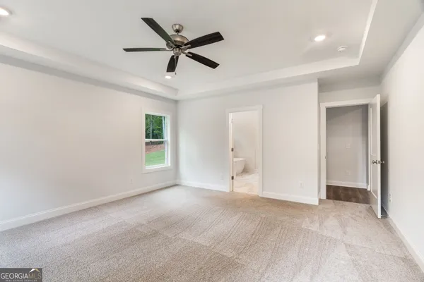 a spacious bathroom with a granite countertop sink and a mirror