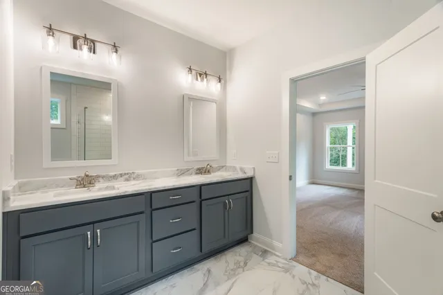 a bathroom with a bathtub shower sink vanity and toilet
