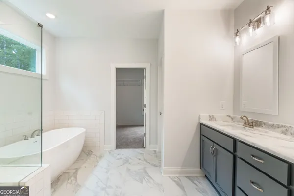 a view of a hallway with wooden floor and a window