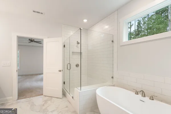 a view of a hallway with entryway and stairs