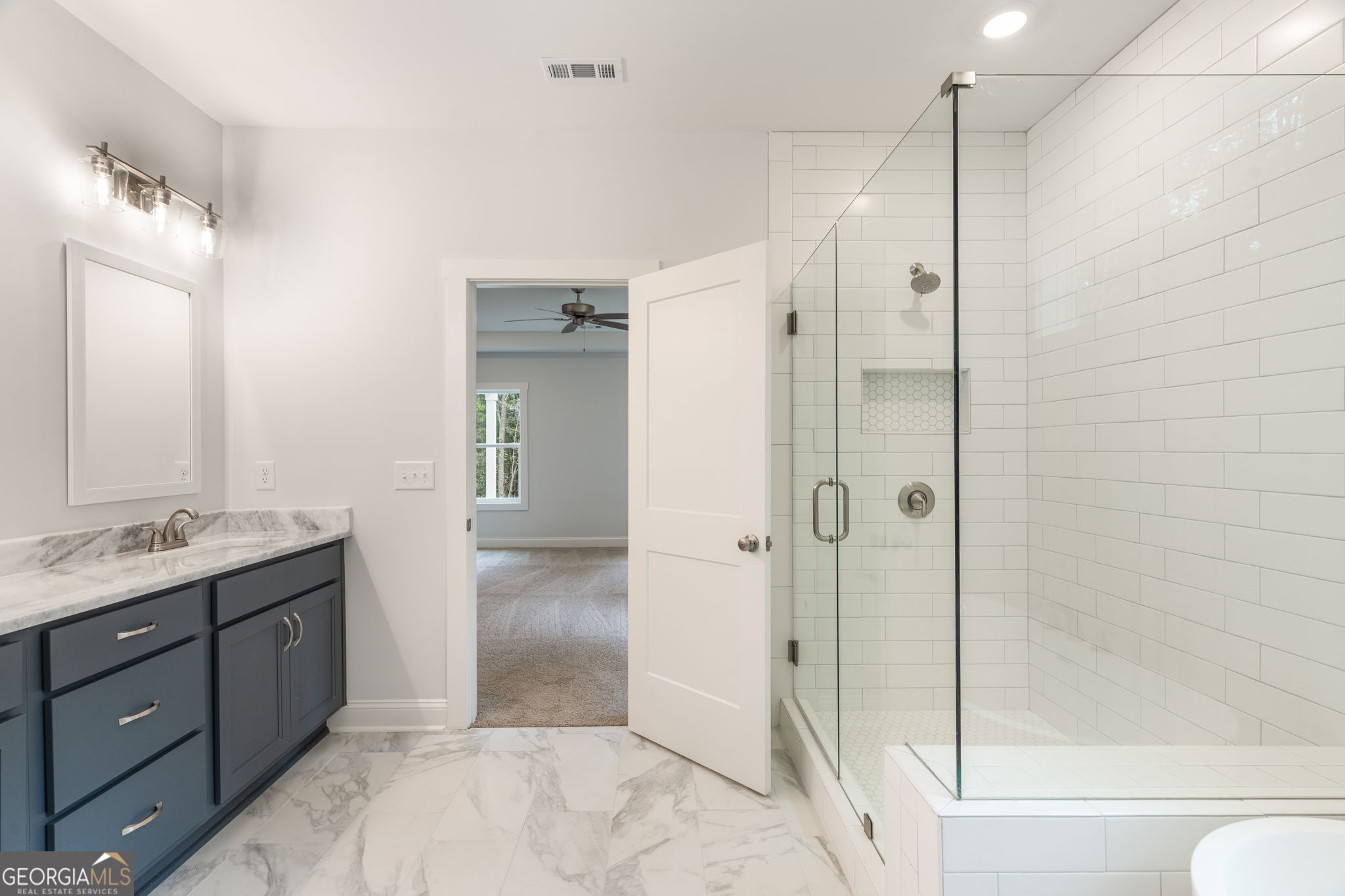 102 Mill Race Road Thomaston, GA 30286 - Photo 30 of 57 a spacious bathroom with a granite countertop sink mirror and shower
