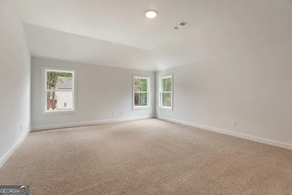 a view of an empty room and a window