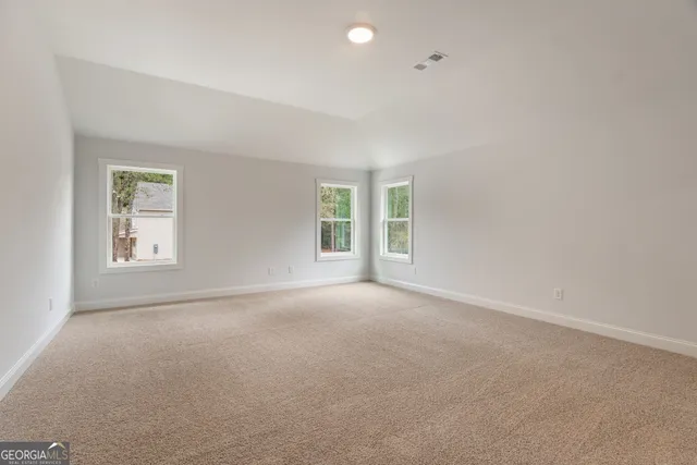 a view of an empty room and a window