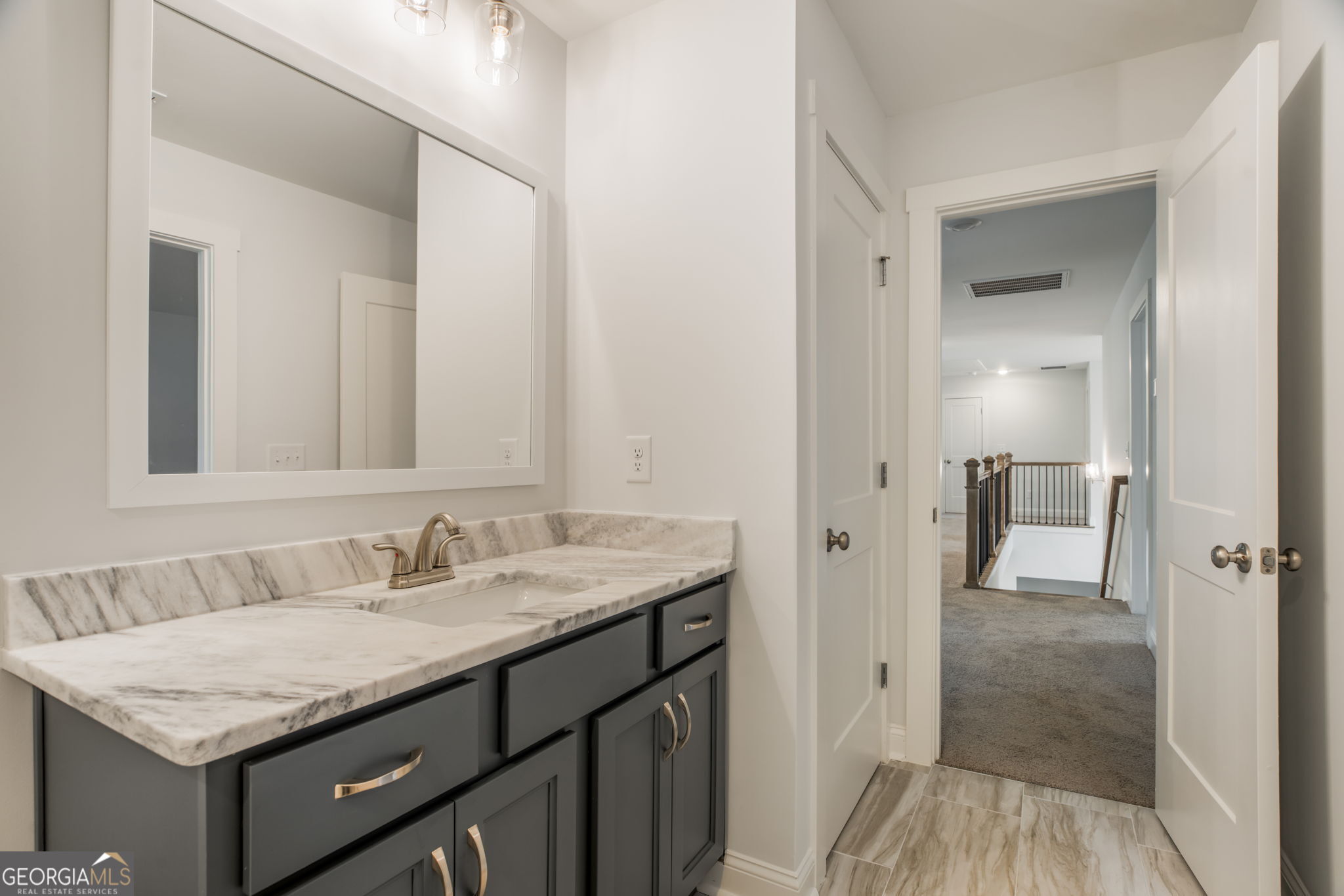 102 Mill Race Road Thomaston, GA 30286 - Photo 40 of 57 a bathroom with a granite countertop sink and a mirror