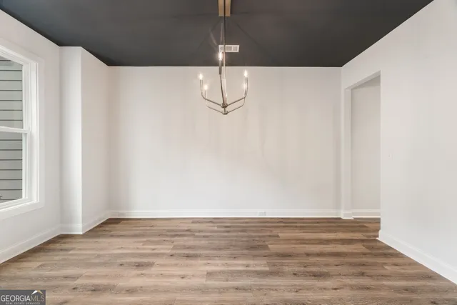 a view of a room with wooden floor