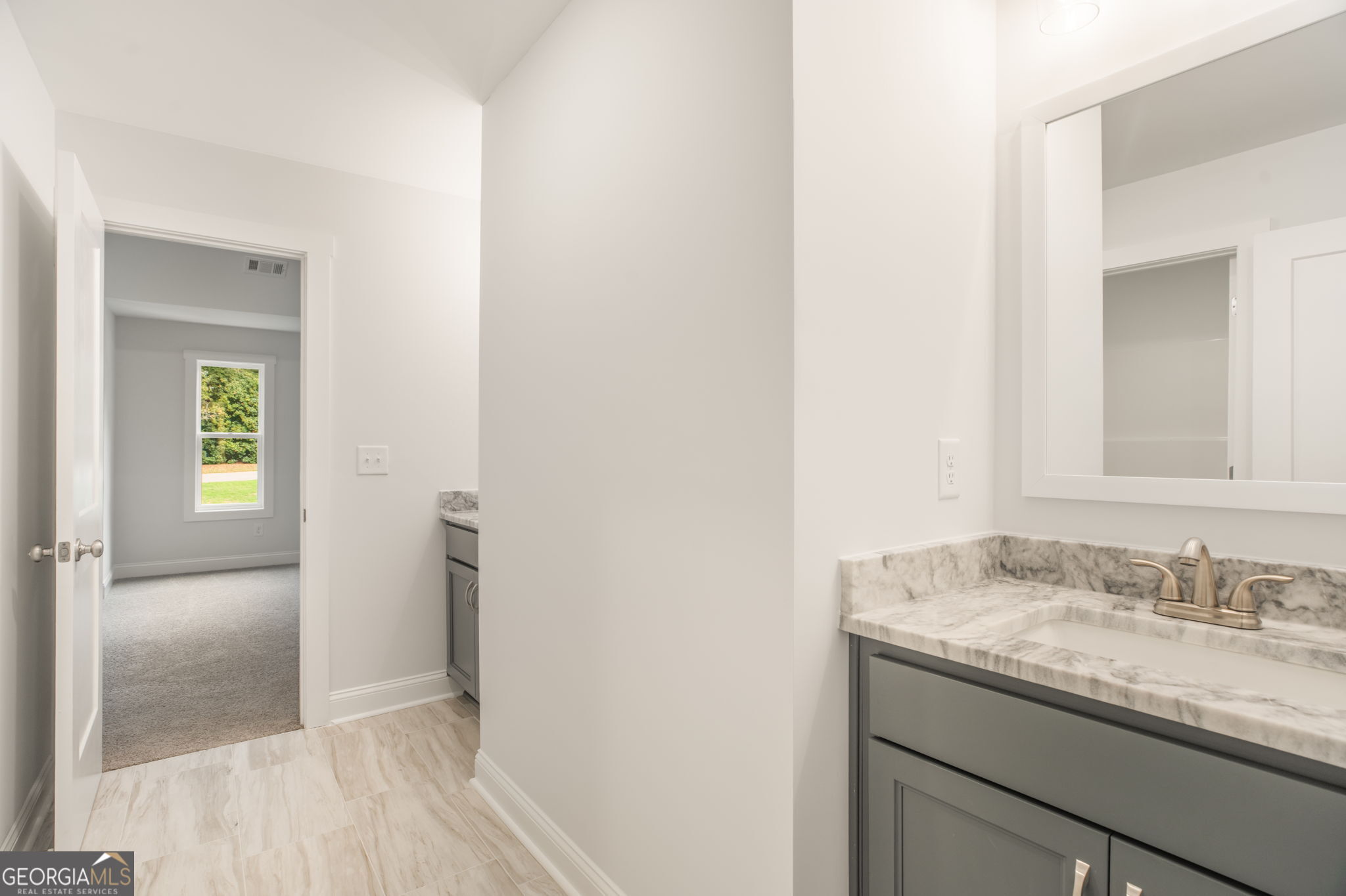 102 Mill Race Road Thomaston, GA 30286 - Photo 48 of 57 a bathroom with a granite countertop sink and a mirror