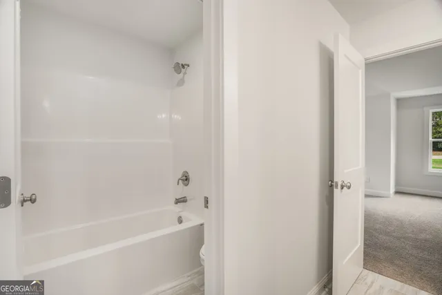 a view of a house with a big yard and large trees