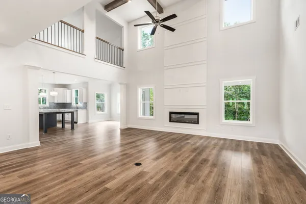 a kitchen with stainless steel appliances granite countertop a kitchen island hardwood floor sink and stove