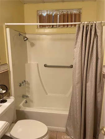 a bathroom with a toilet and a bathtub
