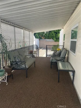 a balcony with chairs and with outdoor seating