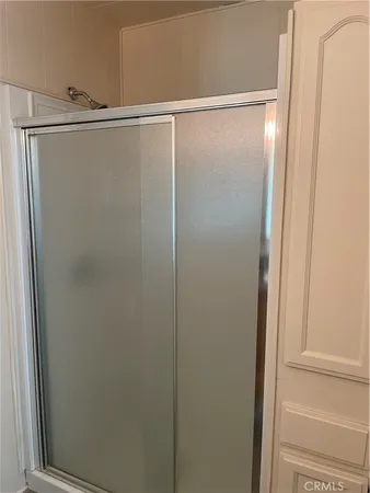 a bathroom with a glass shower door