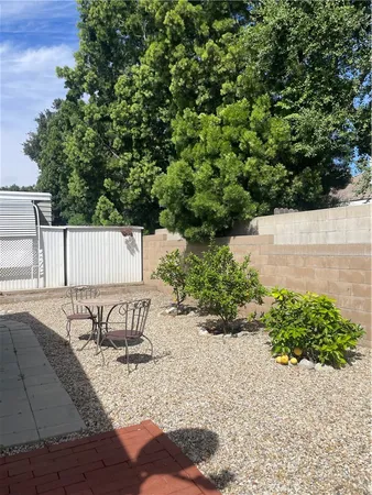 a view of a street with a bench and trees