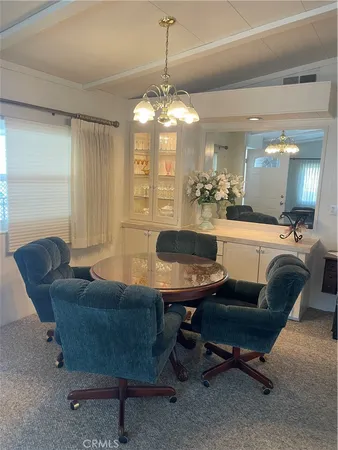 a living room with furniture a table and chairs
