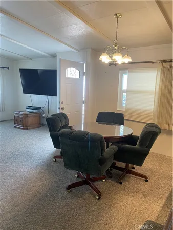 a view of a livingroom with workspace and a window