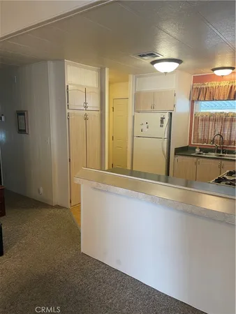 a view of a storage & utility room with two washing machine