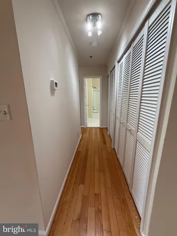 a view of a hallway with wooden floor