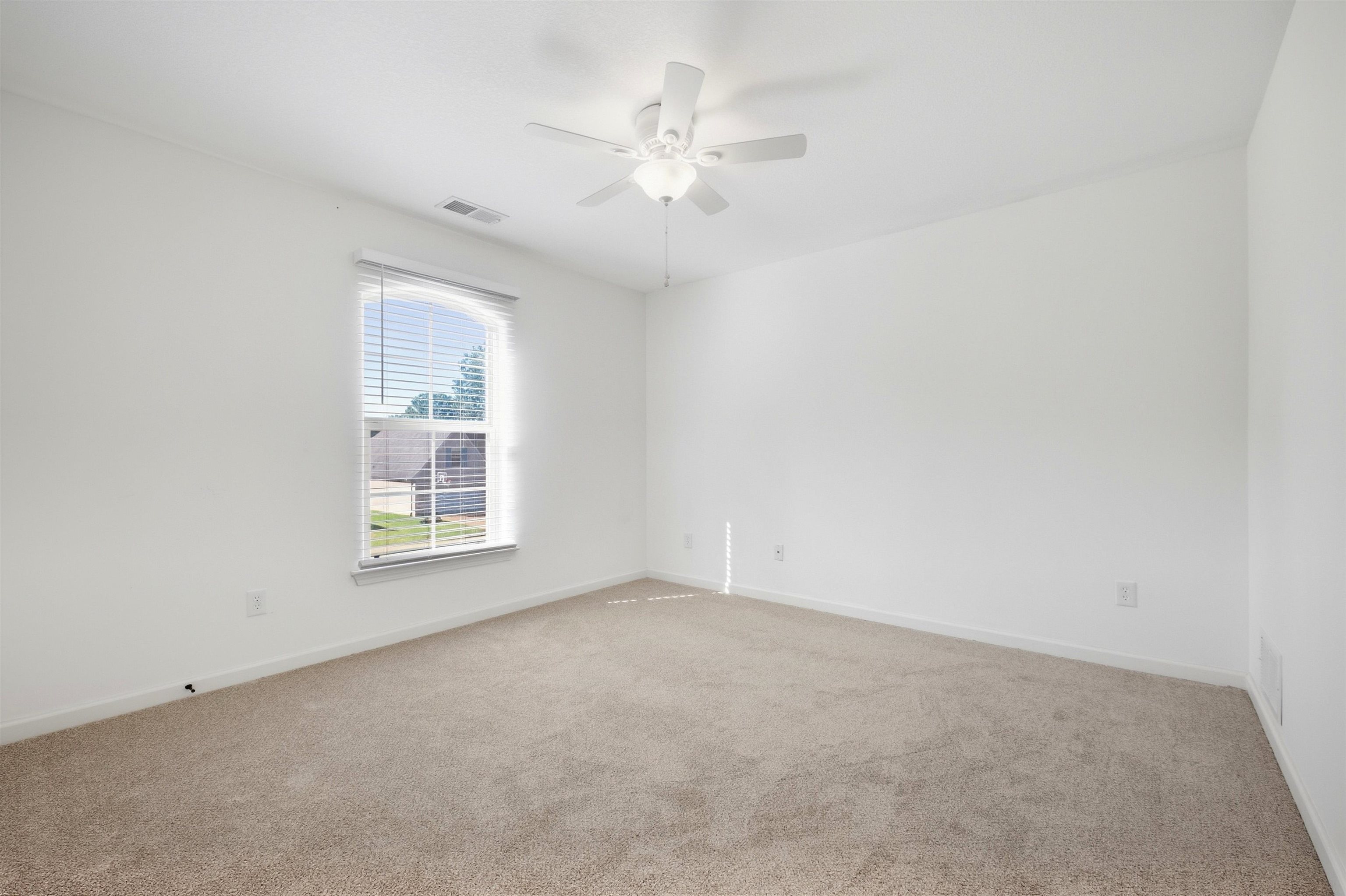 7920 Pips Ridge Lane Bartlett, TN 38133 - Photo 32 of 40 Neutral-toned carpeting paired with white walls, a single window with blinds, and a ceiling fan with integrated lighting