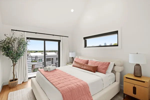 a bedroom with a large bed and a large window