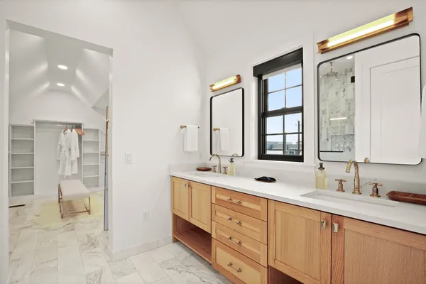 a bathroom with a double vanity sink mirror double and shower