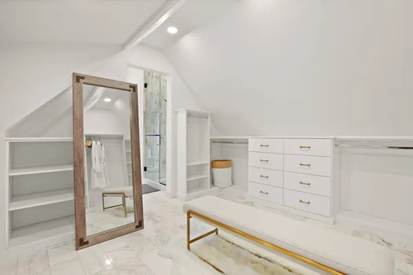 walk in closet with a cabinet and mirror
