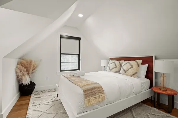 a bedroom with a bed and a window