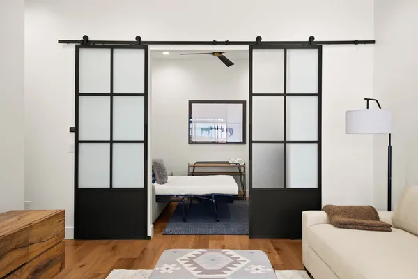 a bedroom with a bed and wooden floor