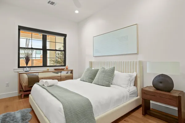 a bedroom with a large bed and a large window