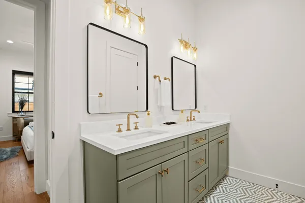 a bathroom with 2 sink and a mirror