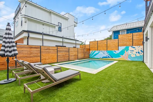 a view of a backyard with chairs