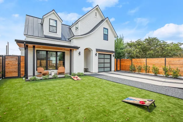a view of a house with a yard and sitting area