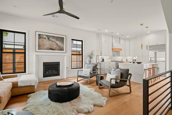 a living room with furniture a rug and a fireplace