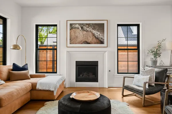 a living room with furniture a window and a fireplace