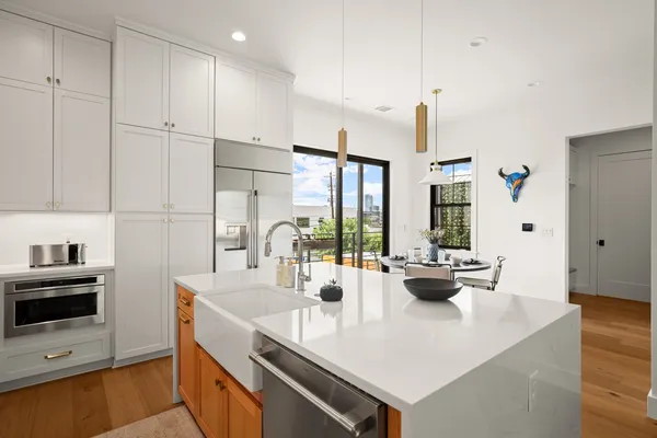 a kitchen with sink stove and refrigerator
