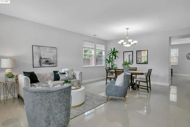 a view of a dining room with furniture and chandelier