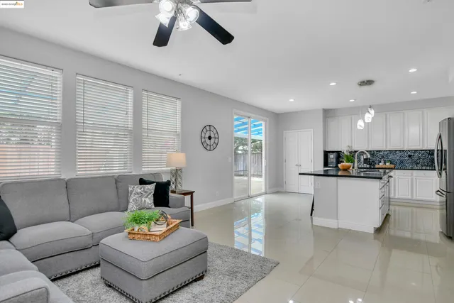 a kitchen with stainless steel appliances granite countertop a refrigerator and white cabinets