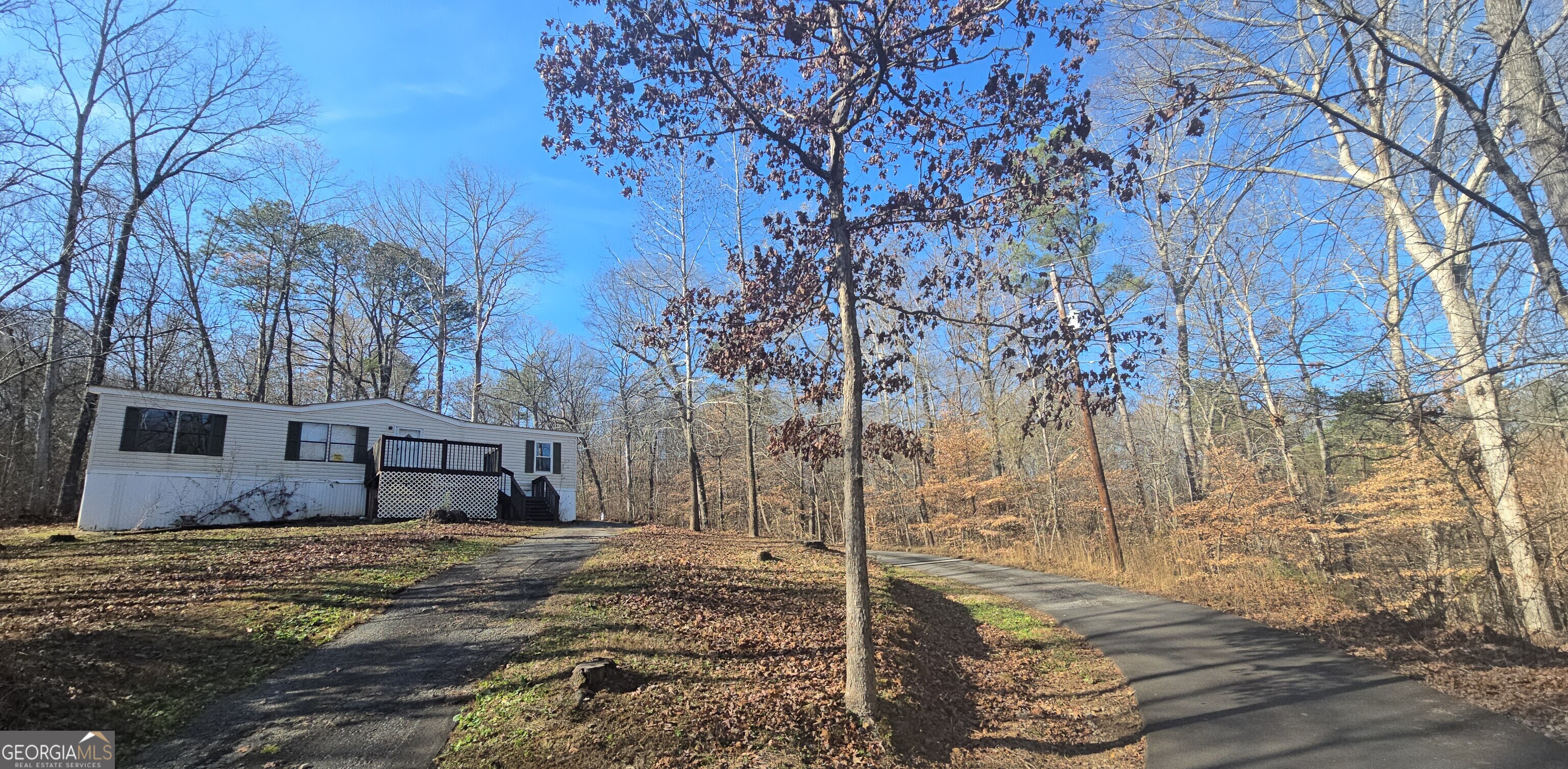a view of a house with a yard covered in snow
