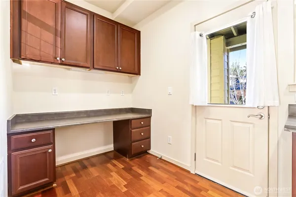 a view of a kitchen with wooden floor and cabinet