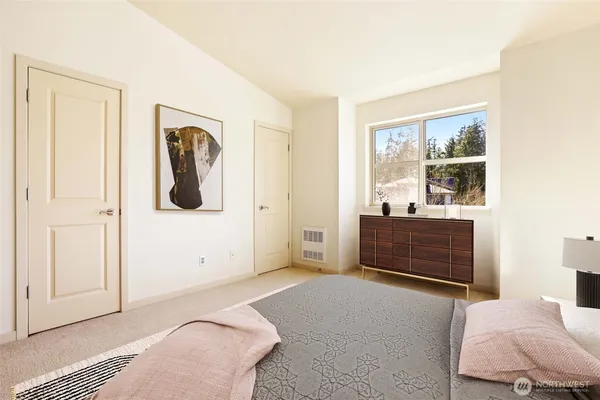 a bedroom with a bed and a painting on the wall