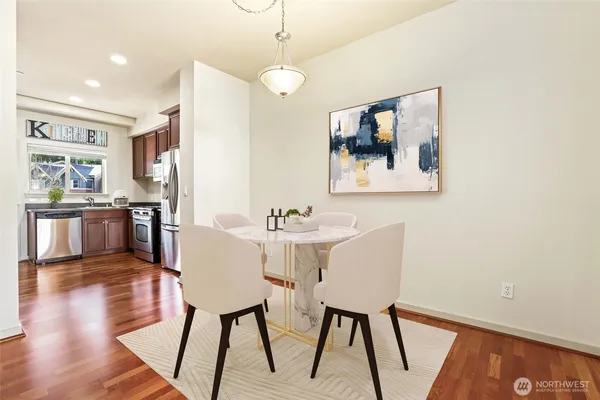 a view of a dining room with furniture and wooden floor