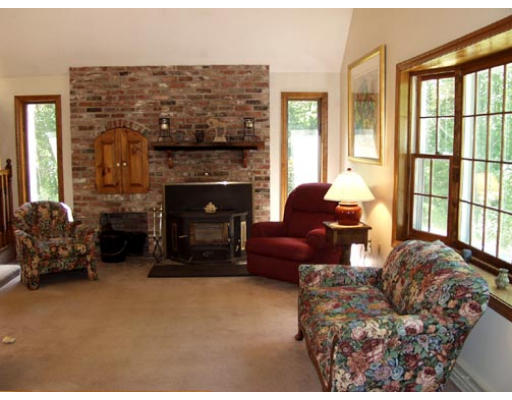 70 Tenney Road Westford, MA 01886 - Photo 5 of 13 a living room with furniture and a fireplace