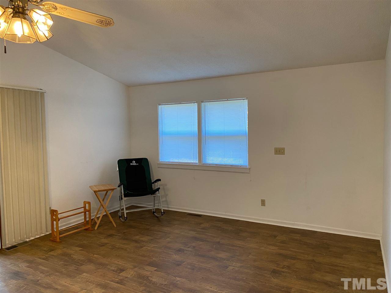 9577 B George Ruff Road Bullock, NC 27507 - Photo 3 of 24 a view of a room with wooden floor and windows