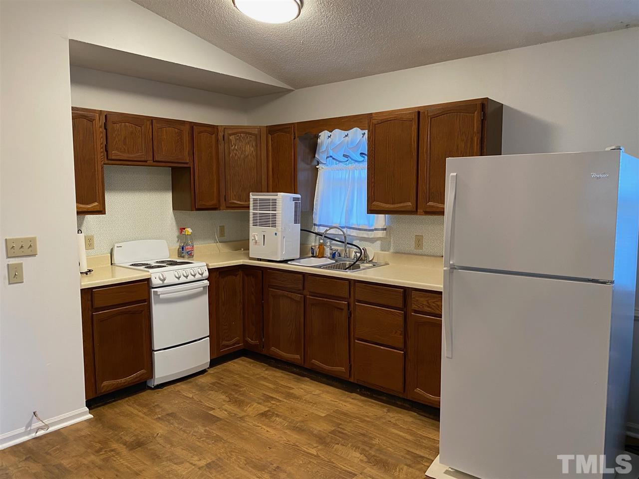 9577 B George Ruff Road Bullock, NC 27507 - Photo 5 of 24 a kitchen with a refrigerator sink and stove