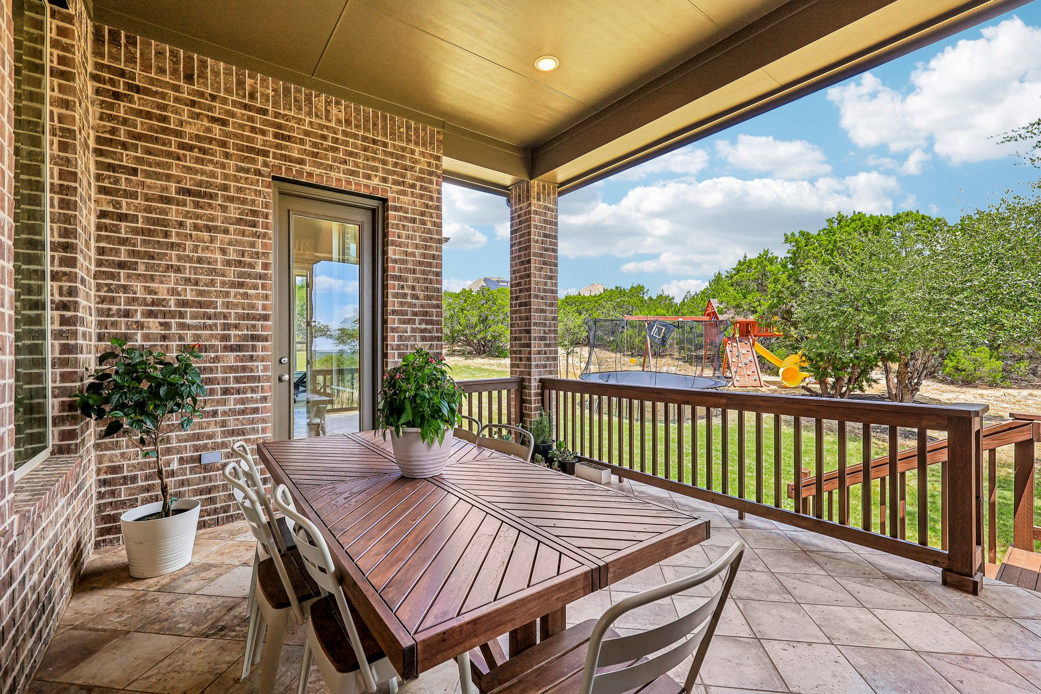 1705 Parten Rnch Parkway Austin, TX 78737 - Photo 30 of 39 An inviting covered patio offers ample space for outdoor dining and entertaining with views of a lush backyard.