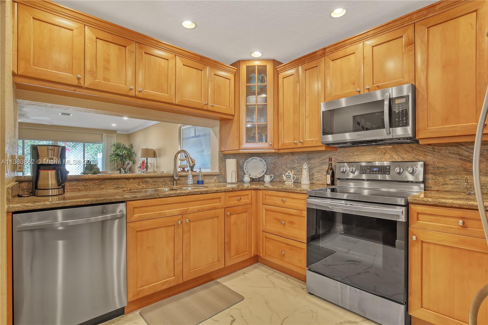 119 Ocean Dunes Circle Jupiter, FL 33477 - Photo 13 of 39 a kitchen with stainless steel appliances granite countertop a sink and cabinets