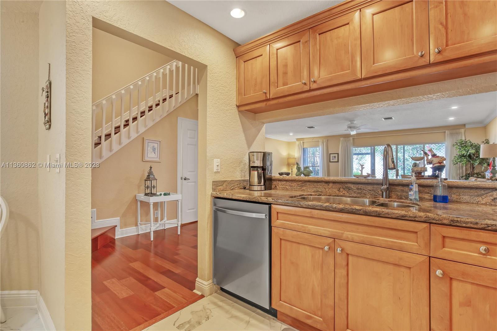 119 Ocean Dunes Circle Jupiter, FL 33477 - Photo 14 of 39 a kitchen with granite countertop a sink and cabinets