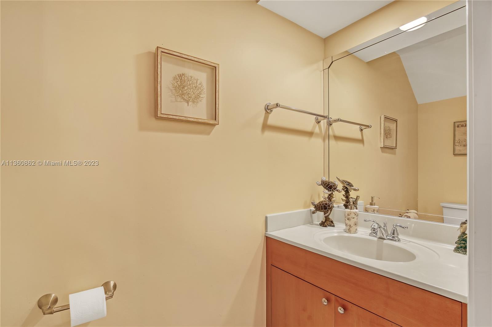 119 Ocean Dunes Circle Jupiter, FL 33477 - Photo 15 of 39 a bathroom with a sink and a mirror