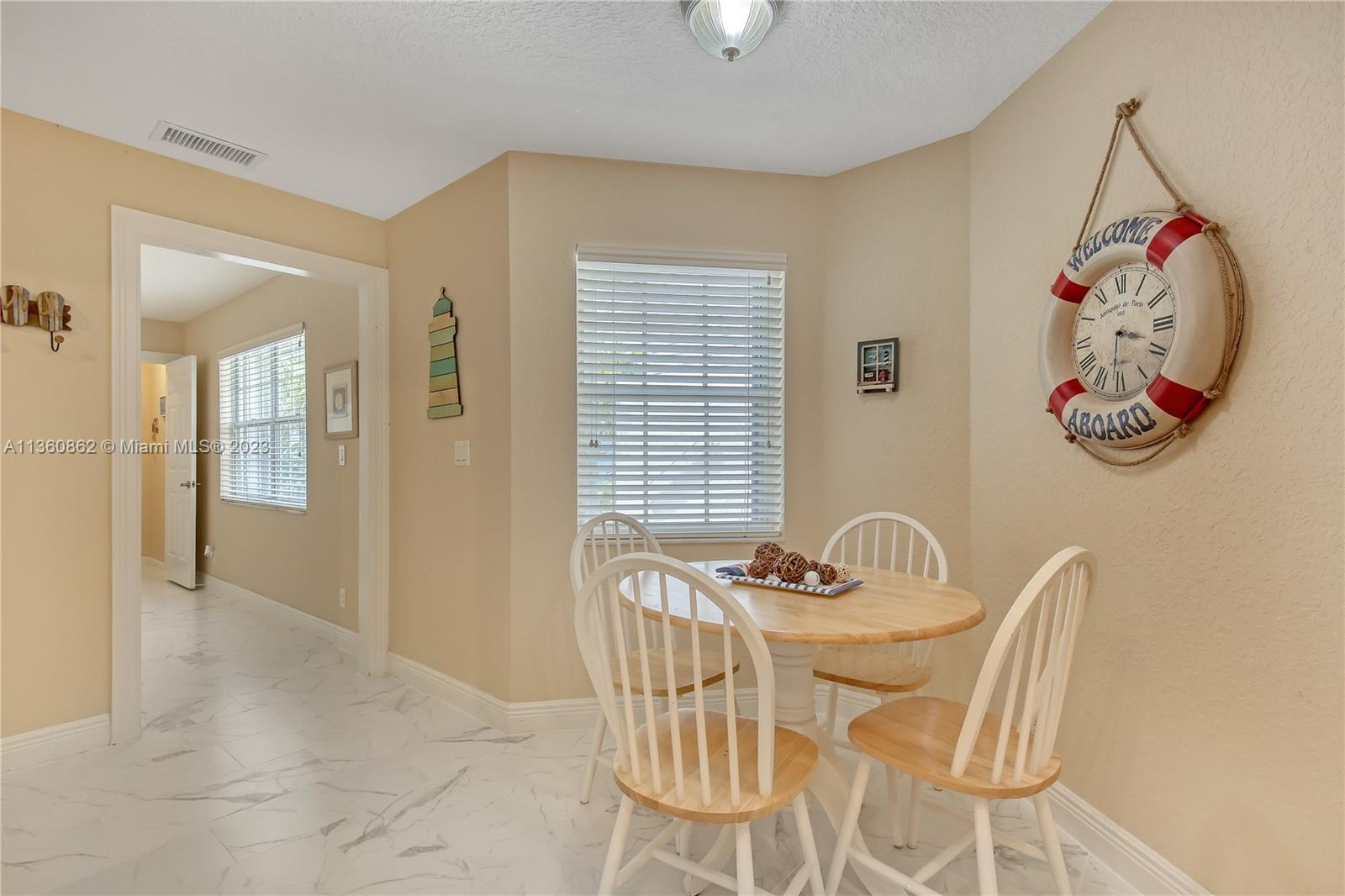 119 Ocean Dunes Circle Jupiter, FL 33477 - Photo 17 of 39 a view of a dining room with furniture and chandelier
