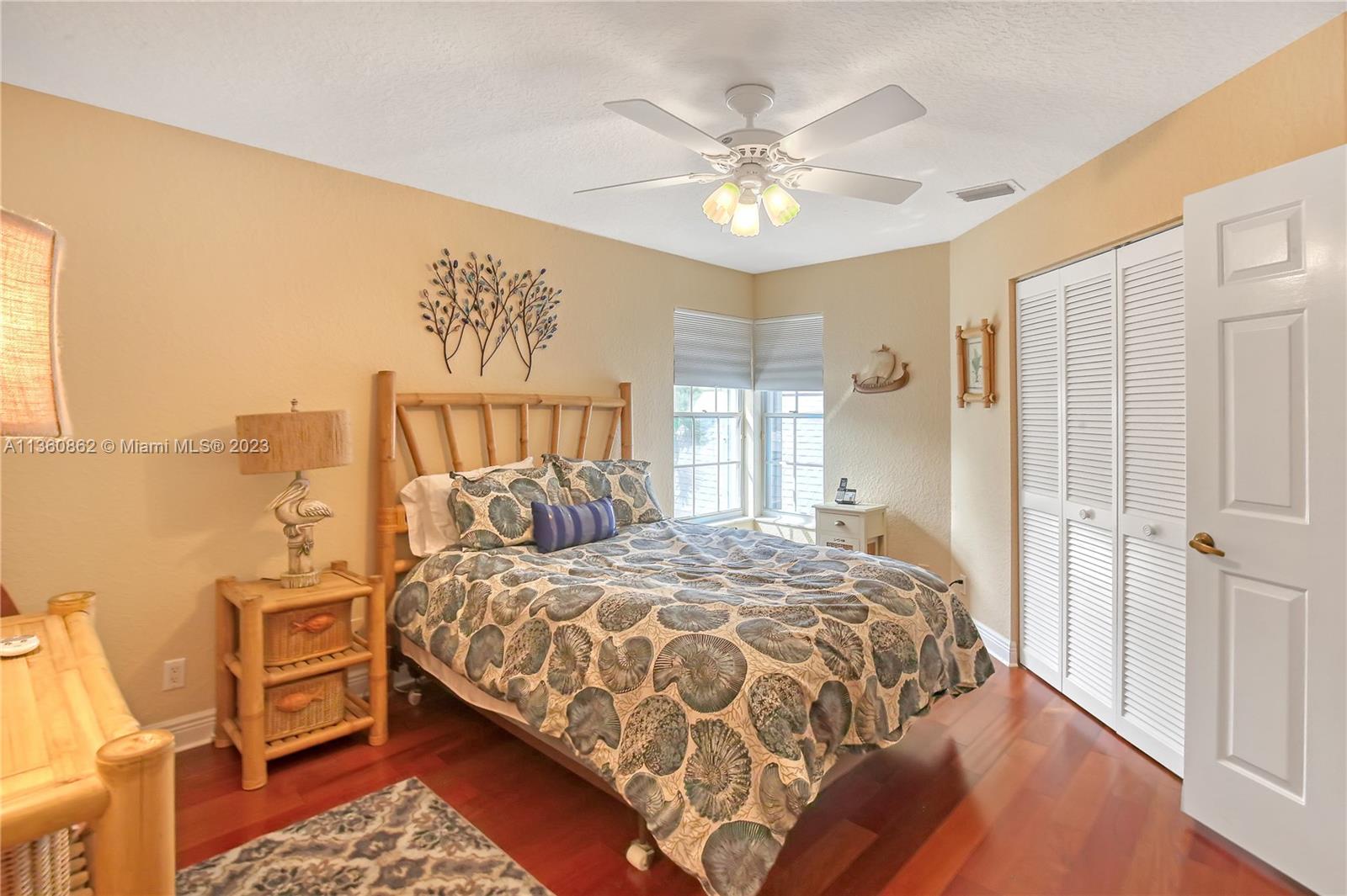 119 Ocean Dunes Circle Jupiter, FL 33477 - Photo 22 of 39 a bedroom with a bed and a chandelier