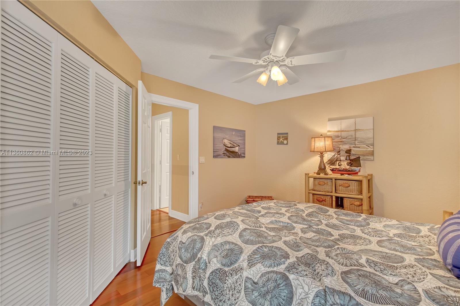 119 Ocean Dunes Circle Jupiter, FL 33477 - Photo 23 of 39 a bedroom with a bed and a chandelier